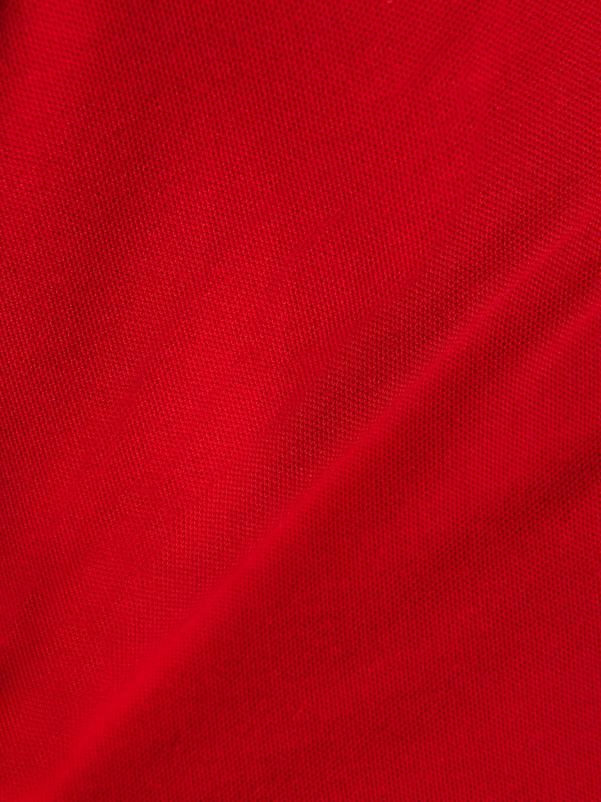 Alpinestars Endeavor Classic Polo, dettaglio del tessuto piqué rosso, materiale in maglia testurizzata, misto cotone-poliestere, abbigliamento sportivo casual motorsport