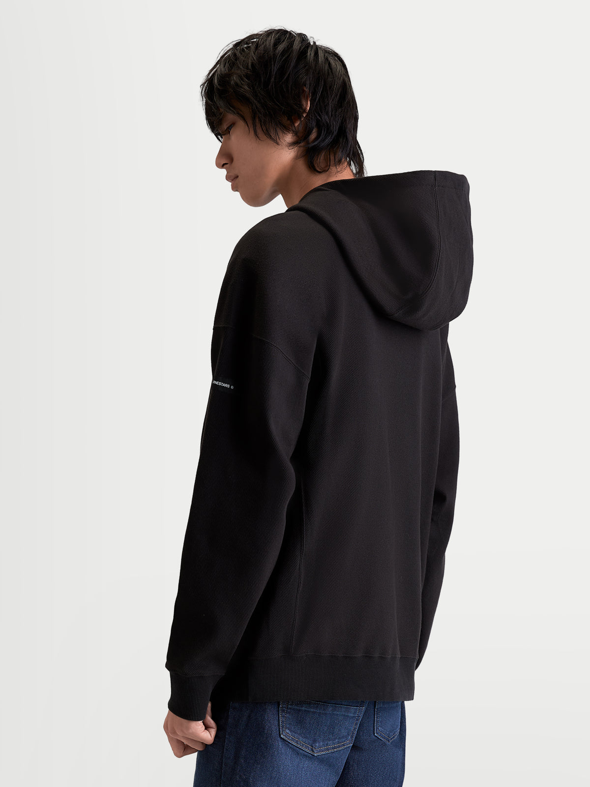 Alpinestars Felpa con cappuccio Camino Textured Oversize, felpa sportswear da uomo, nera, pile in twill lavorato a maglia testurizzato, vista posteriore con silhouette rilassata ed etichetta tessuta sulla manica
