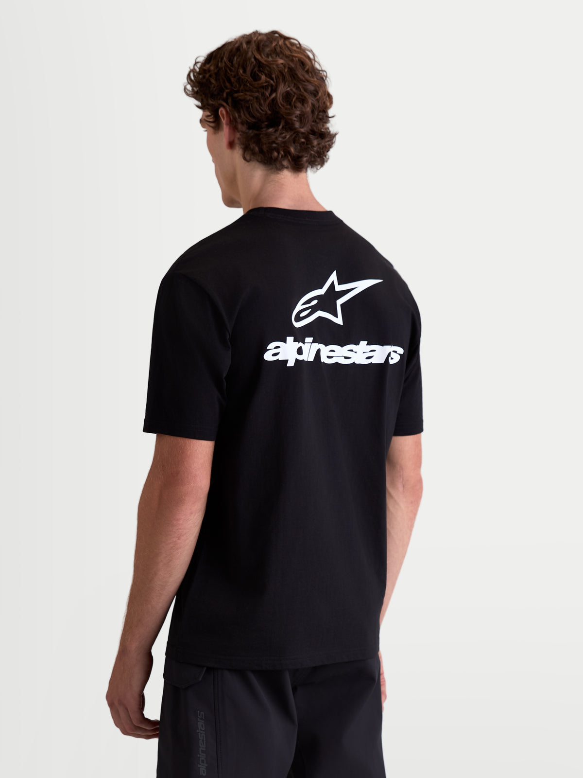 Alpinestars Maglietta Combo Back CSF, maglietta a maniche corte da uomo, nera e bianca, vista posteriore con grande logo Astars e scritta sulla schiena, misto cotone e poliestere, abbigliamento casual motorsport.