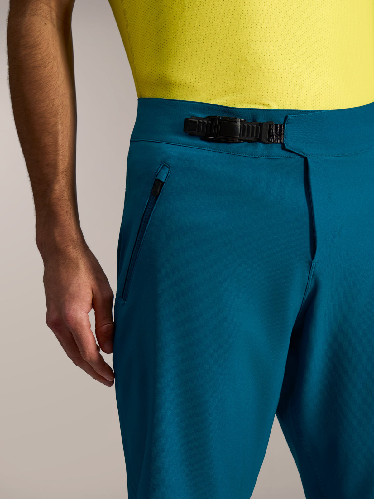 Pantaloncini MTB A-Dura Ride blu-verde, con chiusura a cricchetto in vita e sicure tasche laterali con cerniera.