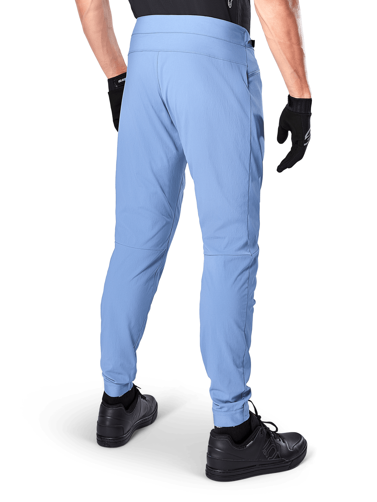 Pantaloni Alpinestars A-Dura, pantaloni da mountain bike, Infinity Blue, vista posteriore che mostra la vestibilità regolare e i polsini elasticizzati, indossati con guanti neri e calzature nere, abbigliamento da ciclismo resistente in tessuto elasticizzato bidirezionale.