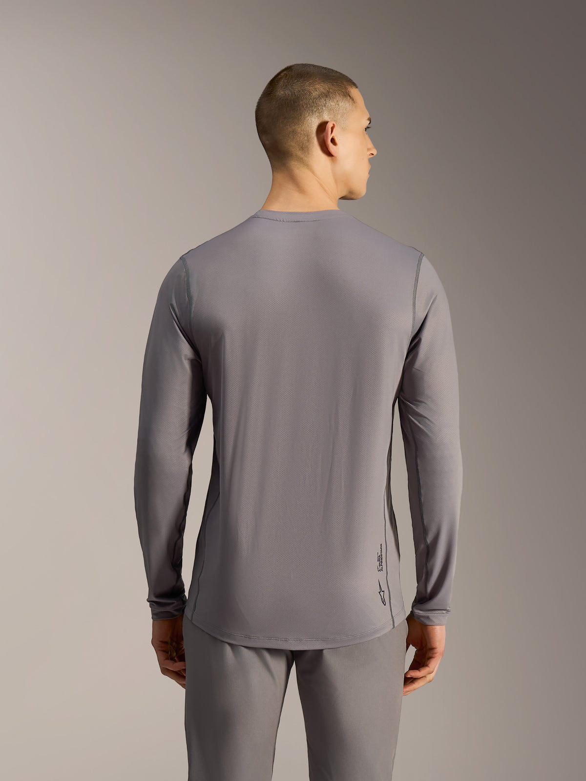 Maglia MTB A-Dura Ride grigia a maniche lunghe, in tessuto jacquard elasticizzato con coda allungata e logo Astars.