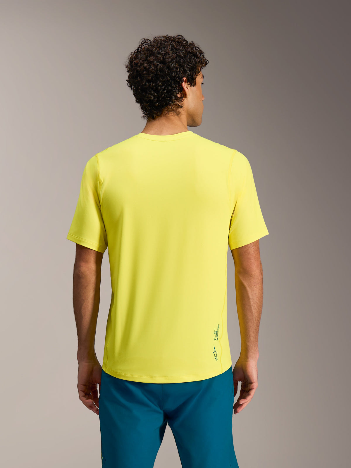 Maglia Alpinestars A-Dura Ride giallo fluo, maniche corte, logo Astars sul retro, vista posteriore.