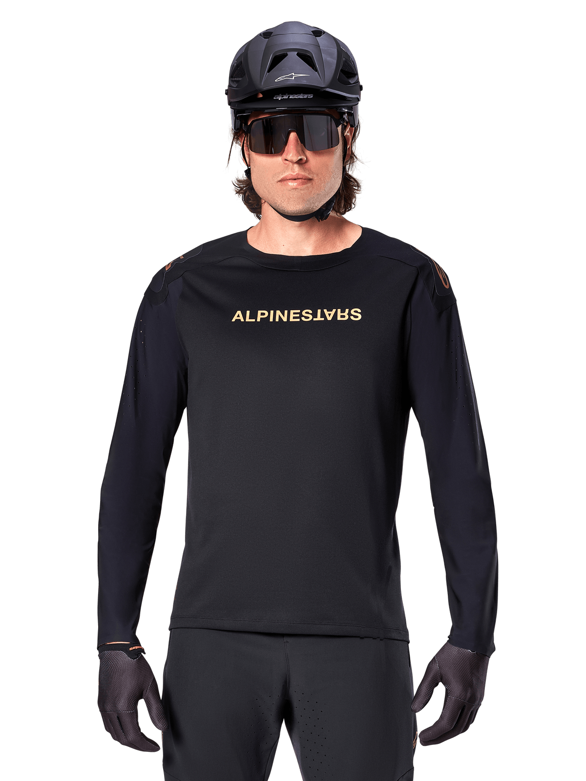 Maglia a maniche lunghe Alpinestars A-Aria Polartec Switch, nero, logo Alpinestars dorato sul petto, indossata con un casco da MTB nero, occhiali da sole scuri e guanti neri, abbigliamento professionale da trail per mountain bike