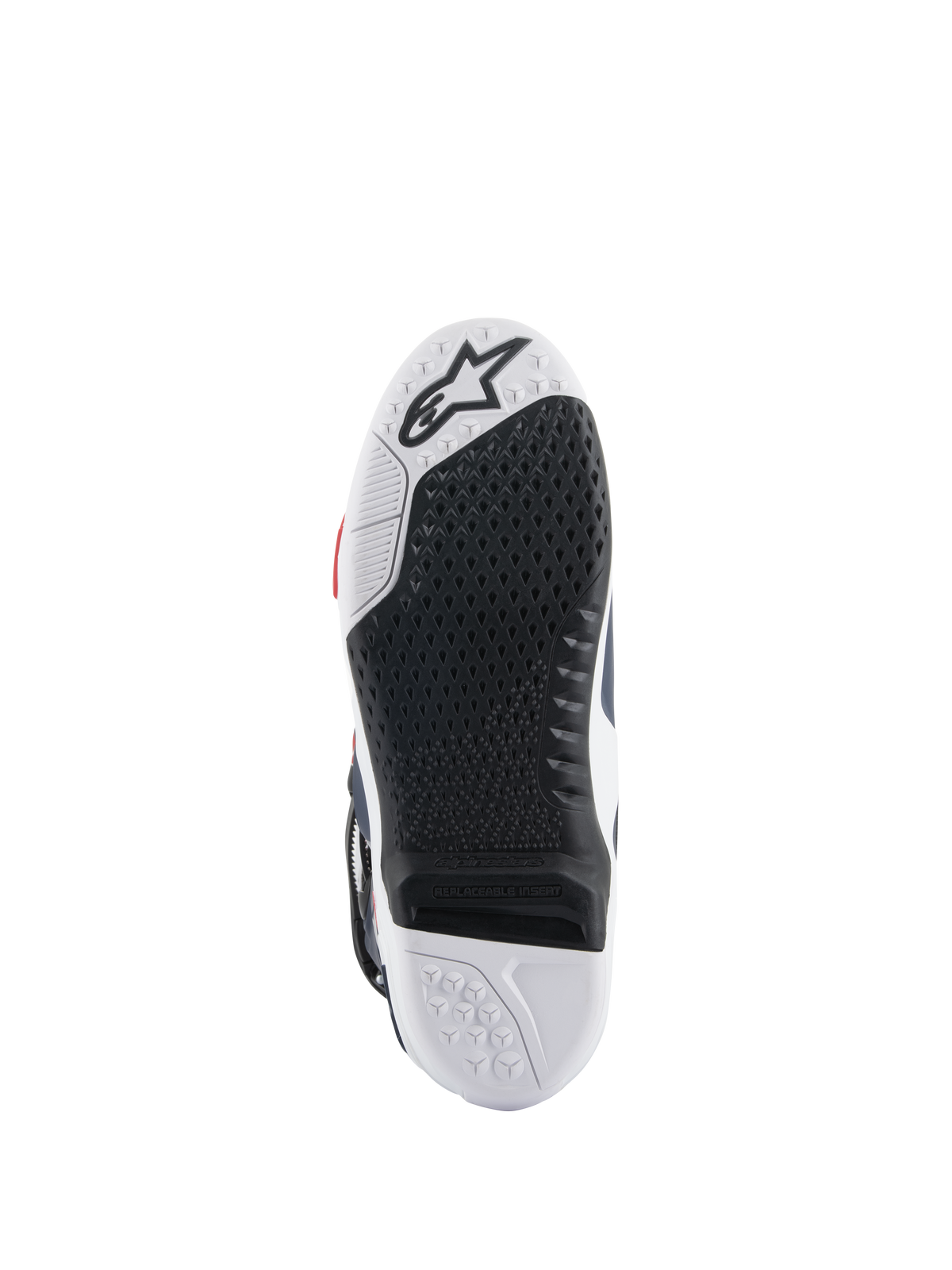 Suola degli stivali Alpinestars Tech 10 Supervented, vista dal basso con design a doppia mescola bianco e nero, trama grip a nido d'ape, inserto centrale sostituibile e logo Alpinestars in rilievo, ottimizzata per le prestazioni sulle pedane da motocross
