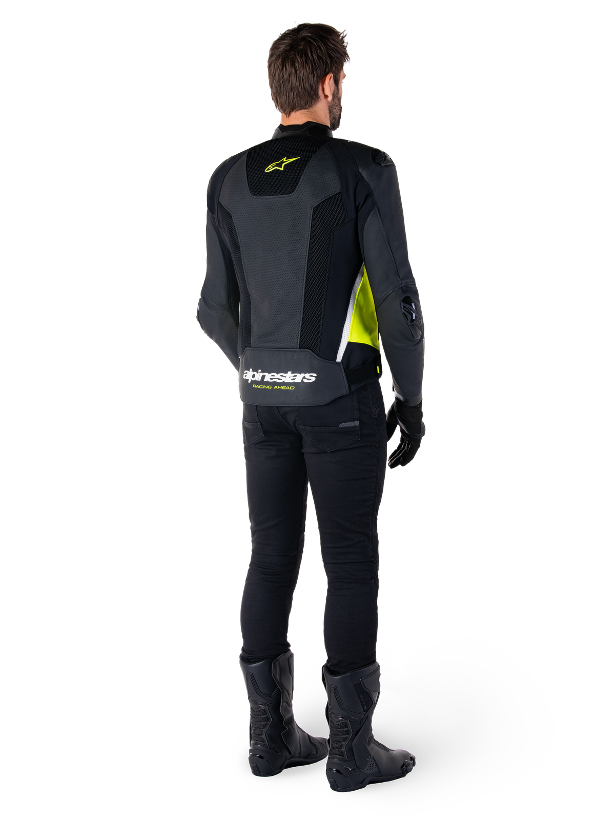 Giacca in pelle Alpinestars Missile V3 Airflow, nero, giallo fluo e bianco, vista posteriore sul pilota, con pannelli posteriori in pelle traforata, logo Alpinestars giallo e dettagli bianchi, indossata con pantaloni e stivali da moto neri