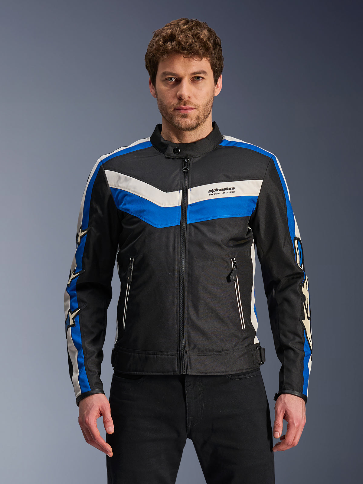 Alpinestars T-Dyno WR Jacket, giacca da moto in tessuto da uomo, nera con strisce blu e bianco ecru, design a chevron sul petto e loghi a stella sulle maniche, zip frontale e tasche, abbigliamento urbano stile heritage