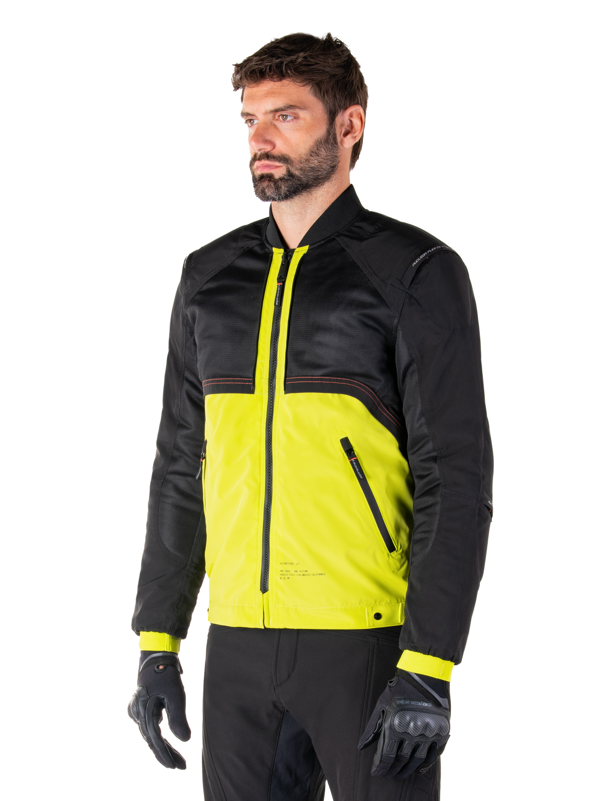 Alpinestars Mootant Waterproof Parka in Lime Punch Black, giacca da moto modulare con parte superiore in rete nera e parte inferiore verde lime vivace, indossata da un motociclista con guanti e pantaloni neri, stile di guida urbano contemporaneo