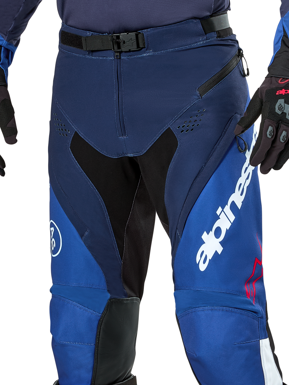 Alpinestars Pro-Dura Pants, pantaloni da enduro e motocross, blu navy, azzurro e bianco, vista ravvicinata della chiusura in vita con fibbia magnetica SX2, prese d'aria con zip sulle cosce e pannelli elasticizzati con logo bianco