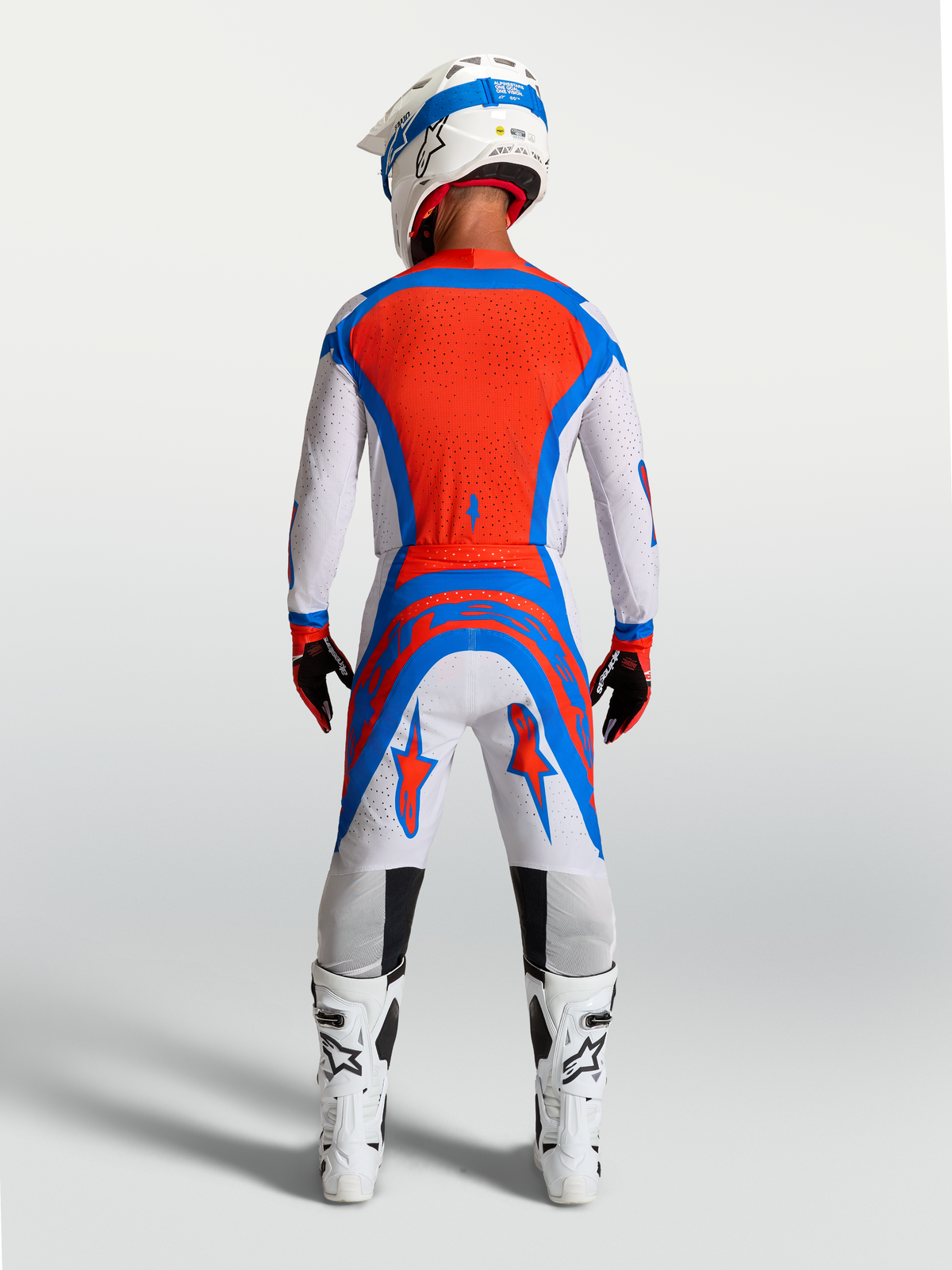 Alpinestars Pantaloni Supertech Vesta, pantaloni da motocross lilla chiaro e rossi, vestibilità atletica, vista posteriore.