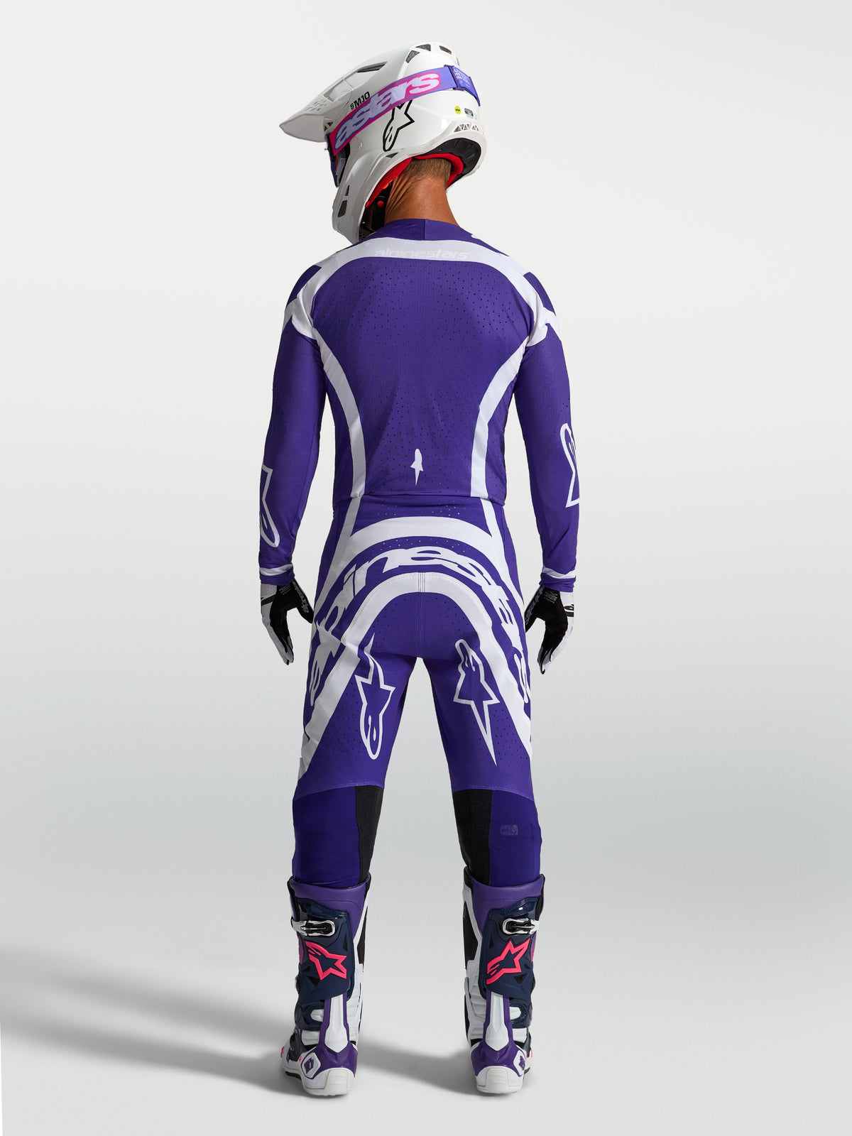 Pantaloni e maglia Alpinestars Supertech Vesta, completo da motocross racing blu e bianco, vista posteriore su modello.