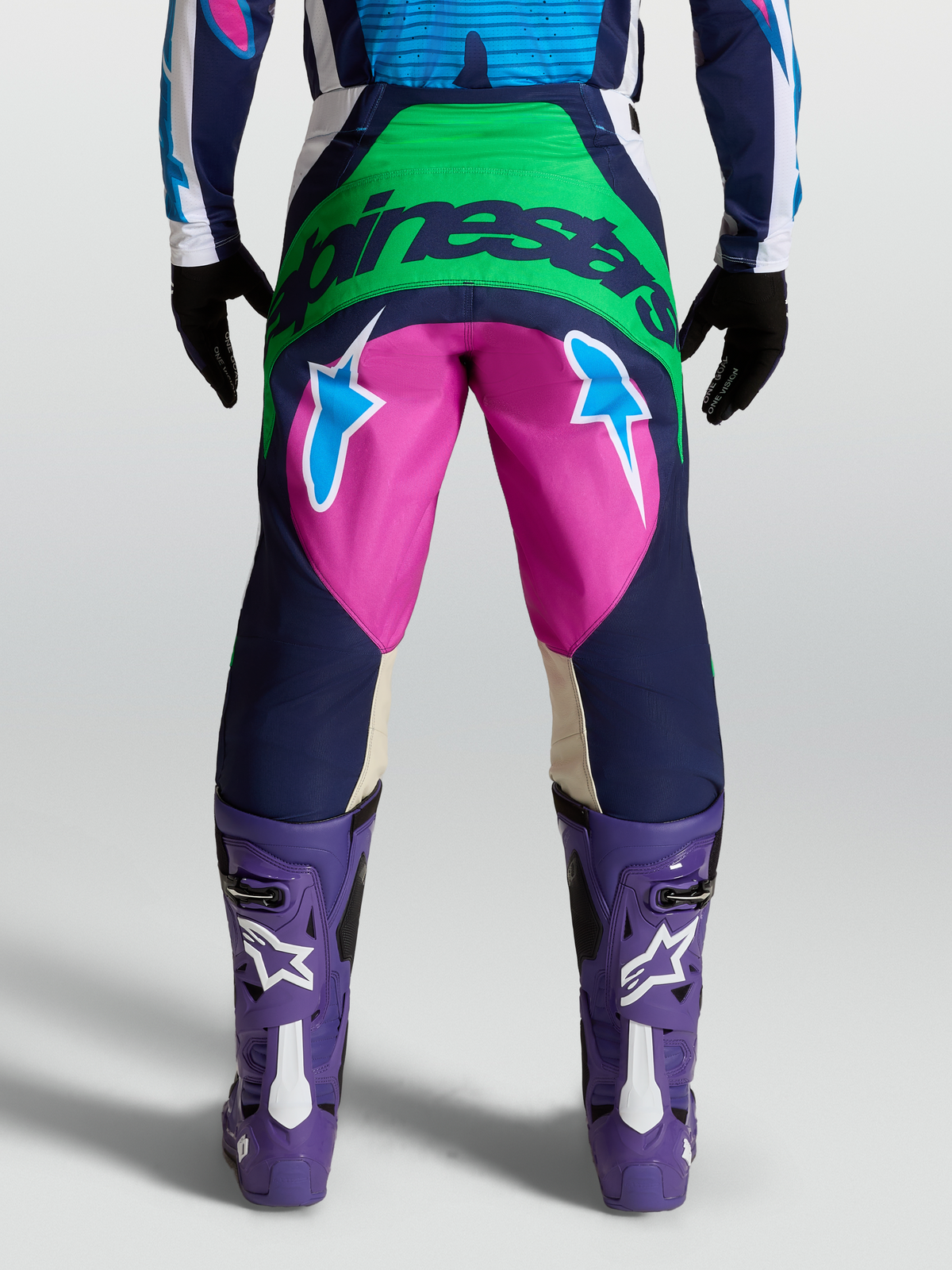 Alpinestars Pantaloni Techstar Maven, pantaloni motocross da uomo, blu e rosa, vista posteriore con grafica logo e stelle.