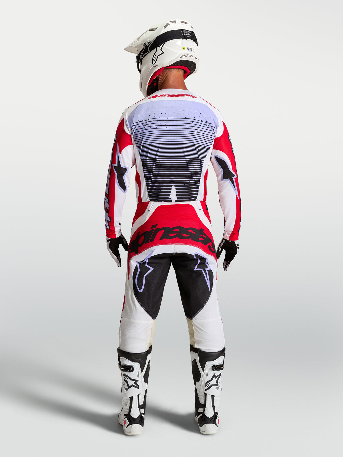Alpinestars Pantaloni Techstar Maven, pantaloni motocross rosso e bianco, vista posteriore, vestibilità da gara atletica.