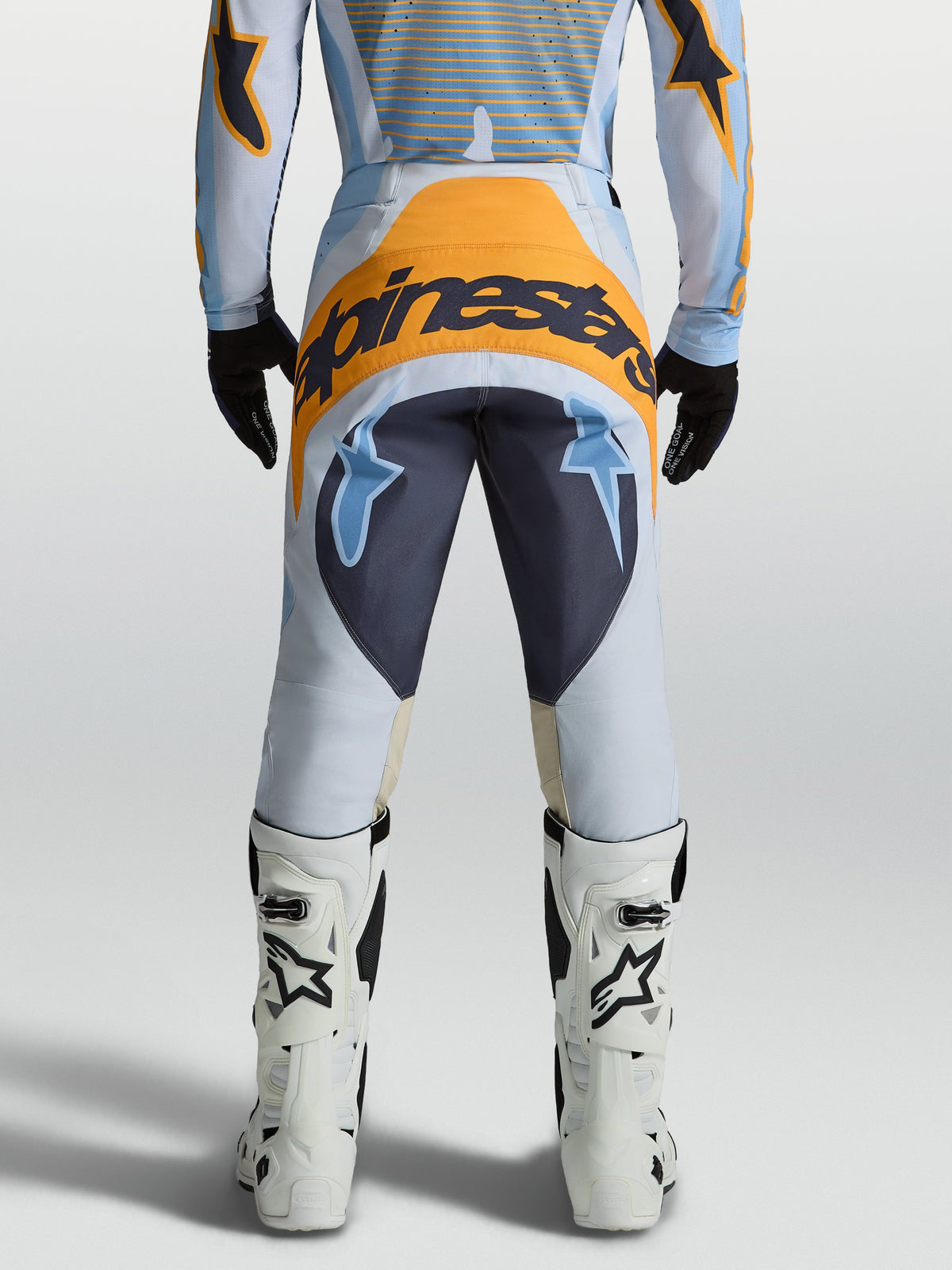 Alpinestars Pantaloni Techstar Maven, pantaloni motocross da uomo, blu e arancione, vista posteriore, in polyfabric 600D.