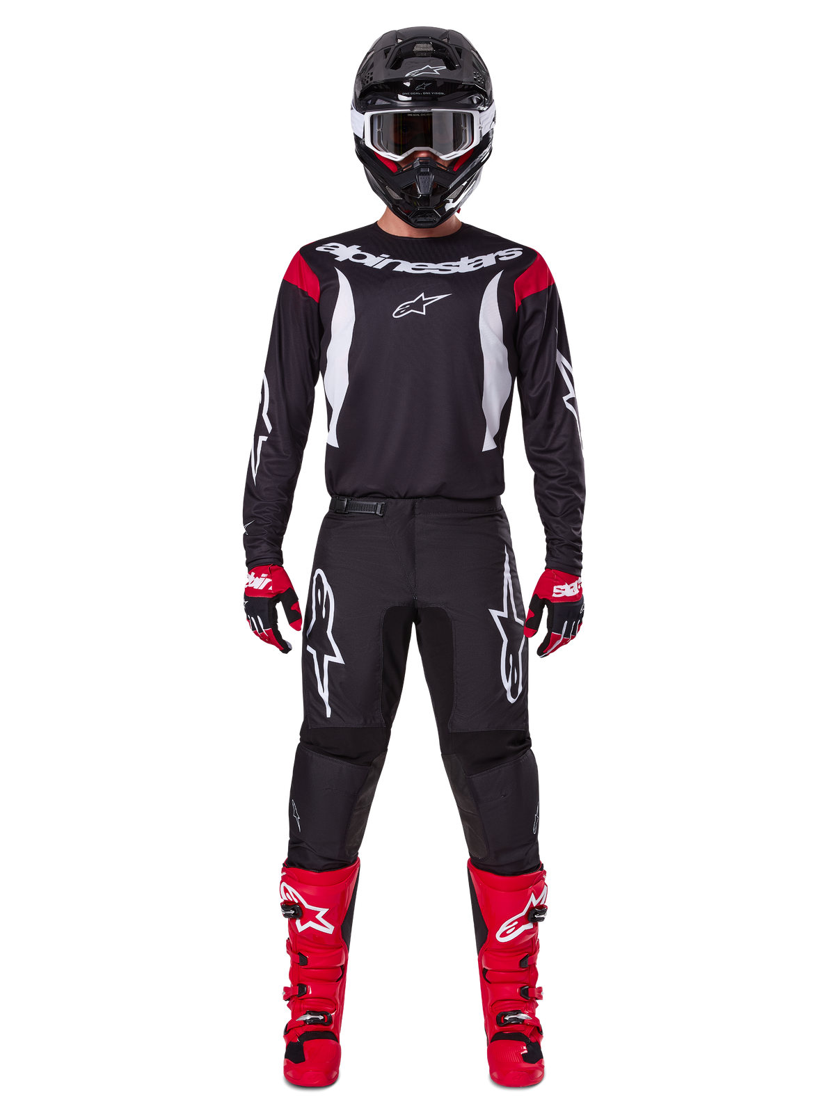 Alpinestars 2025 Fluid Haul Gear Set, pilota di motocross in abbigliamento completo, maglia nera con dettagli rossi sulle spalle e loghi bianchi, pantaloni neri con logo a stella bianco, stivali rosso acceso, guanti rossi e neri, casco nero con occhiali bianchi, look coordinato per prestazioni off-road