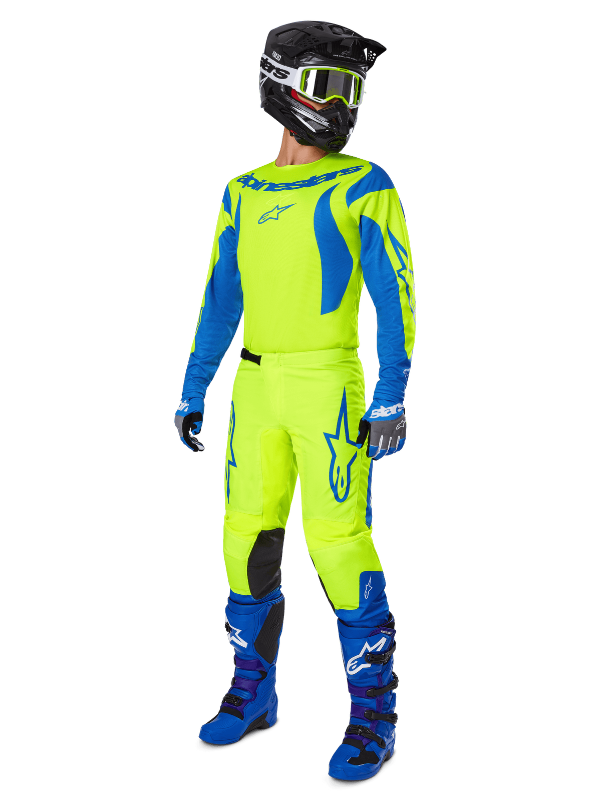 Alpinestars 2025 Fluid Haul Pants, pantaloni da motocross, giallo fluo e blu, indossati come parte di un set completo da gara con maglia coordinata, stivali blu e casco nero, design ad alta visibilità per la guida fuoristrada