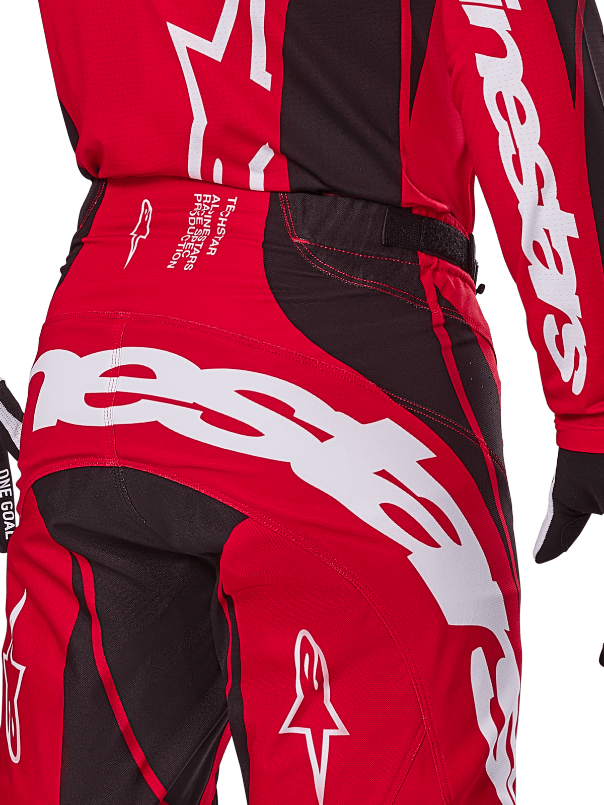 Alpinestars 2025 Techstar Dreem Pants, pantaloni da motocross, rosso acceso e nero, primo piano della zona posteriore della vita e della seduta con branding Alpinestars bianco, pannelli elasticizzati neri e testo tecnico sulla fascia in vita, progettati per prestazioni racing fuoristrada