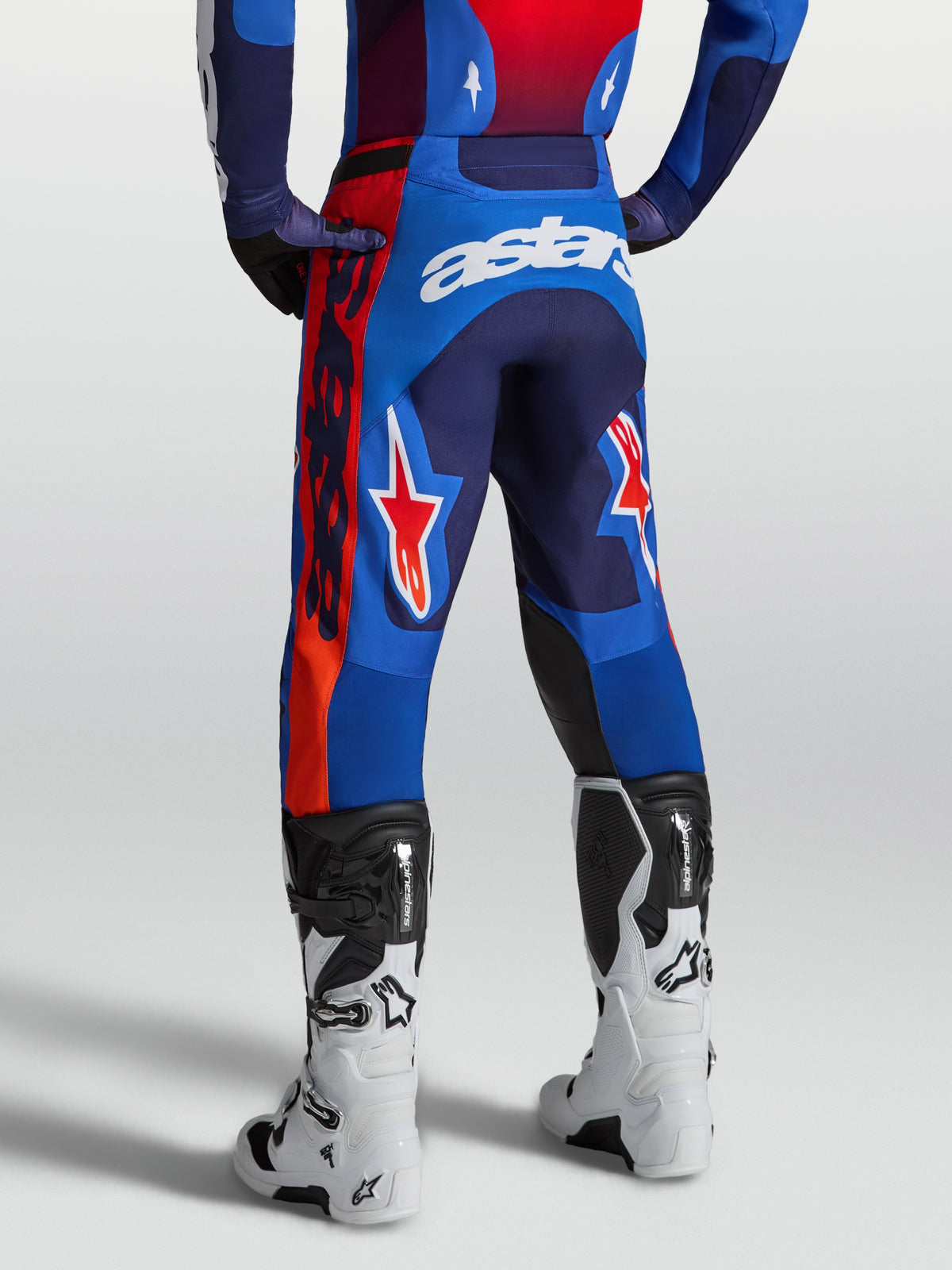 Alpinestars Pantaloni Racer Hunt, pantaloni da motocross da uomo, blu e rosso, vestibilità race fit pre-curvata, vista posteriore con logo astars bianco e dettagli grafici, abbigliamento tecnico per performance off-road