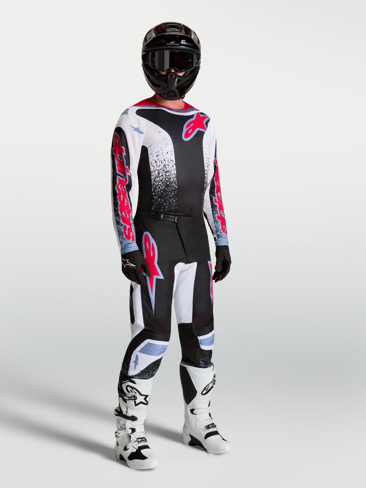 Alpinestars pantaloni Fluid Drag, completo da motocross da uomo in nero e bianco con accenti rosso fluo.