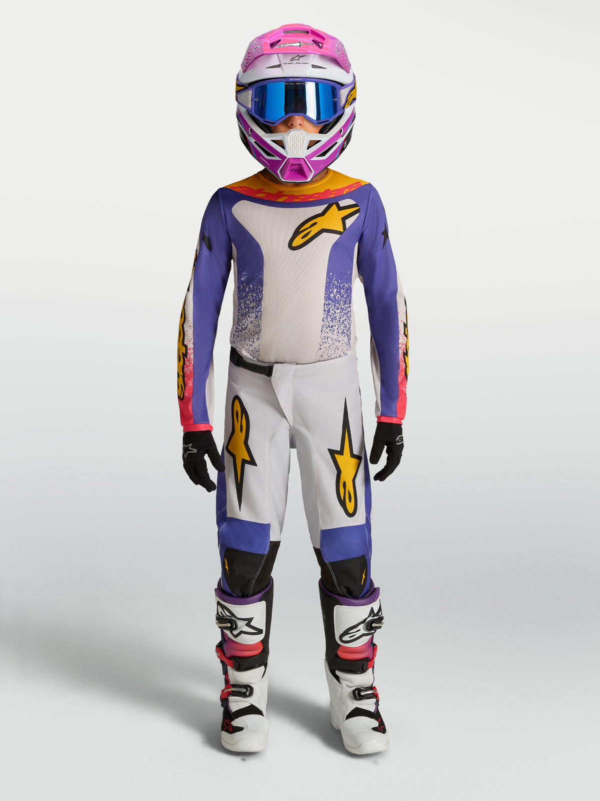 Alpinestars Pantaloni Fluid Drag Ragazzo 2027, completo da motocross viola e bianco con dettagli oro, per guida off-road.
