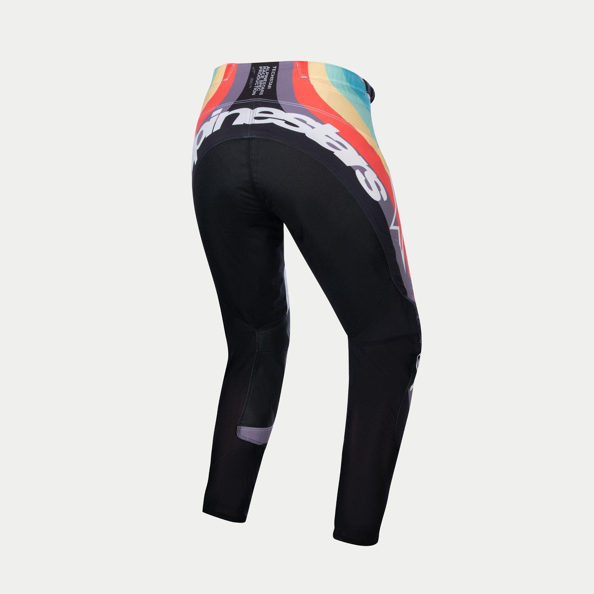 Alpinestars Stella Techstar Pants 2024 da donna, pantaloni da motocross, nero multicolore, vista posteriore con vivace motivo a onde rosso, arancione e blu in vita, grande marchio Alpinestars bianco sul retro, progettati per corse fuoristrada