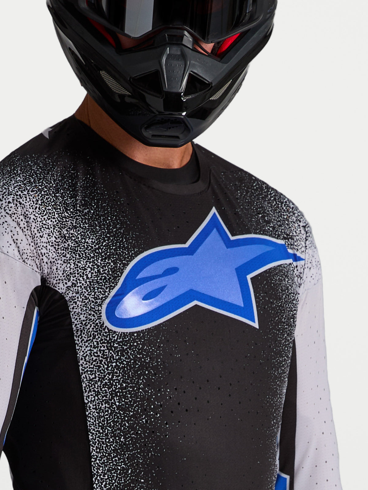 Alpinestars Maglia Supertech Hiten AFD, maglia motocross da uomo, nera e blu, con ventilazione laser-cut e logo a stella.