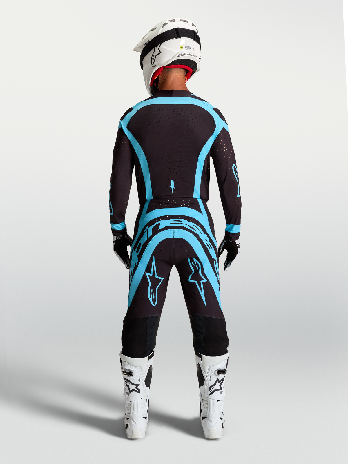 Alpinestars Completo Supertech Vesta, maglia e pantaloni da motocross da uomo, nero e turchese, vista posteriore, vestibilità atletica per gare off-road