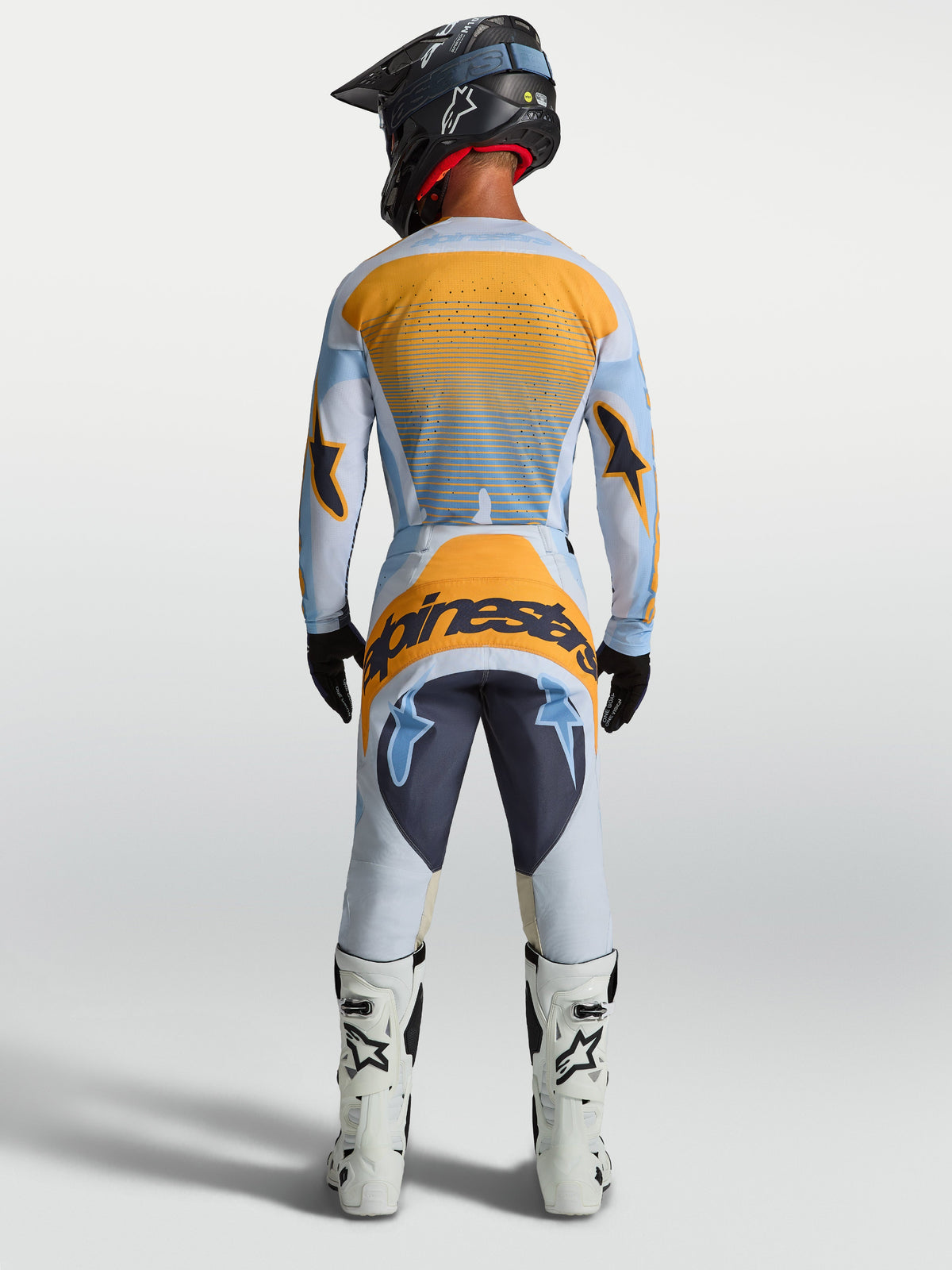 Alpinestars maglia Techstar Maven e gear set da motocross uomo, blu polvere e arancione, vista posteriore.