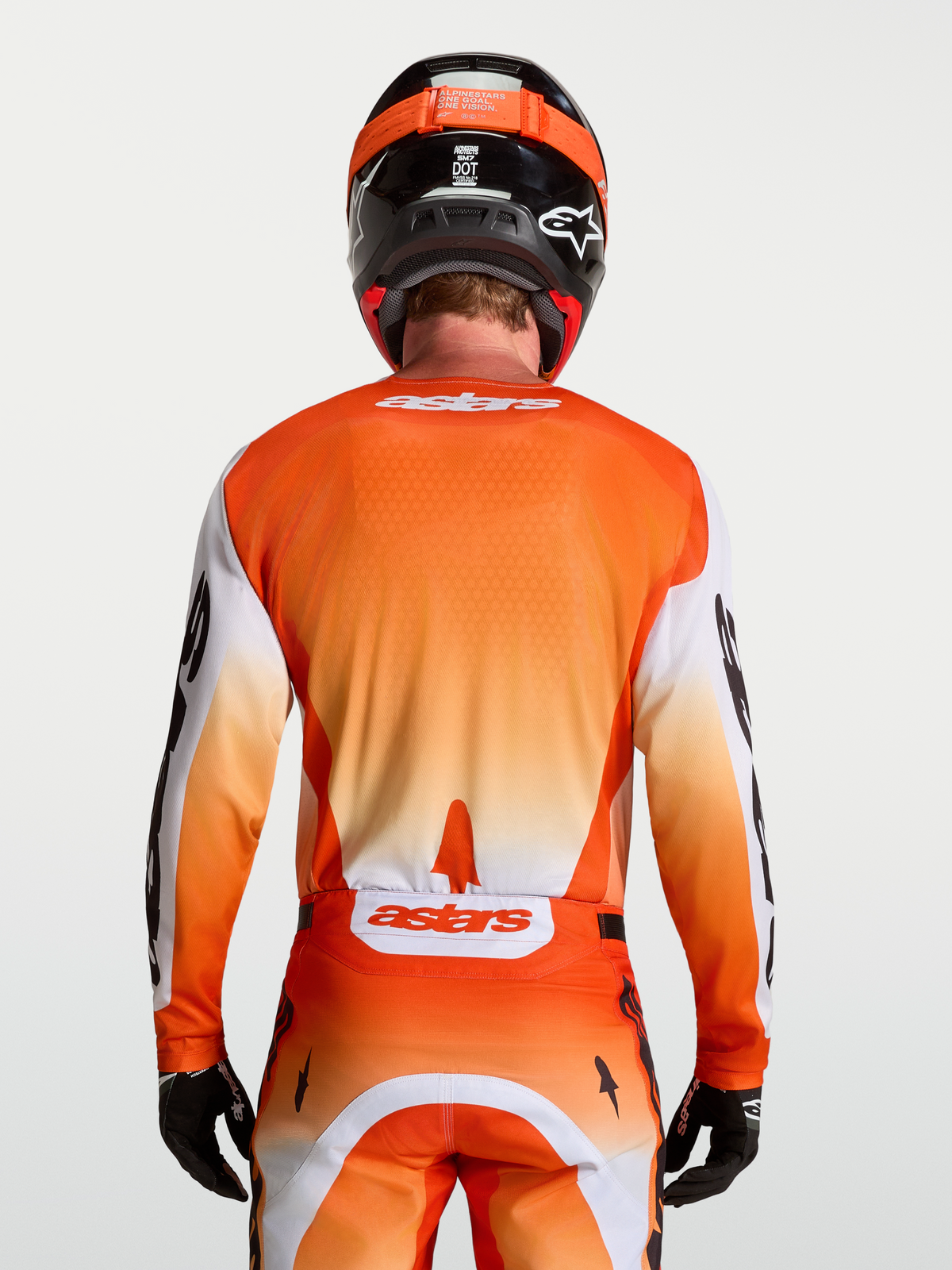 Alpinestars Maglia Racer Amber, maglia motocross da uomo, vista posteriore, arancione e bianca, tessuto tecnico traspirante.