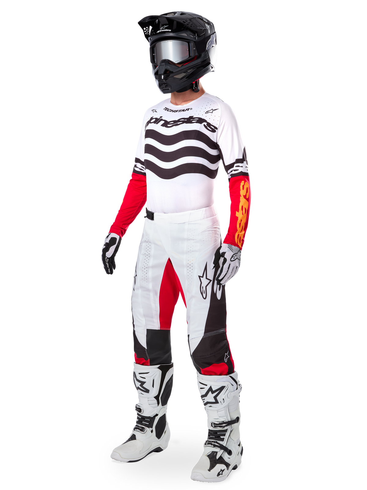 Alpinestars Limited Edition Techstar Deep Gear Set, abbigliamento completo da motocross, maglia bianca con motivi a onde neri e maniche rosse, pantaloni bianchi con dettagli rossi e neri, casco nero con occhiali argento, guanti bianchi e neri, stivali bianchi, completo da gara MX coordinato