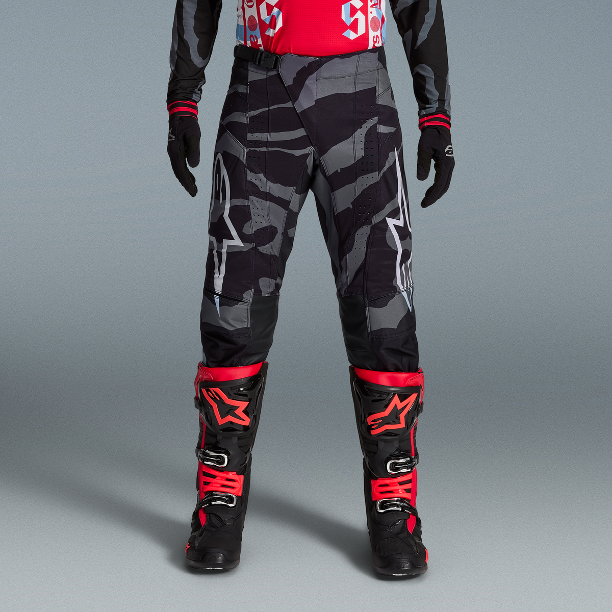 Completo Techstar Beast Coast Alpinestars, pantaloni camo grigi e stivali rossi e neri, abbigliamento MX edizione limitata.