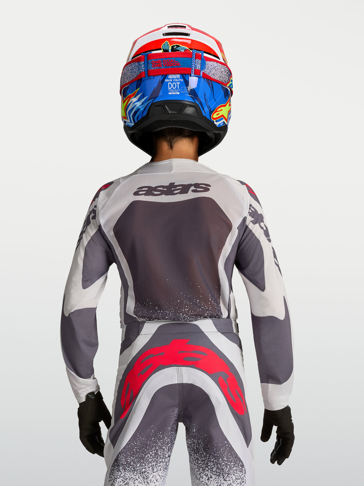 Alpinestars maglia e pantaloni Supertech Swan Ragazzo, grigi e bianchi con accenti rosso fluo, vista posteriore.