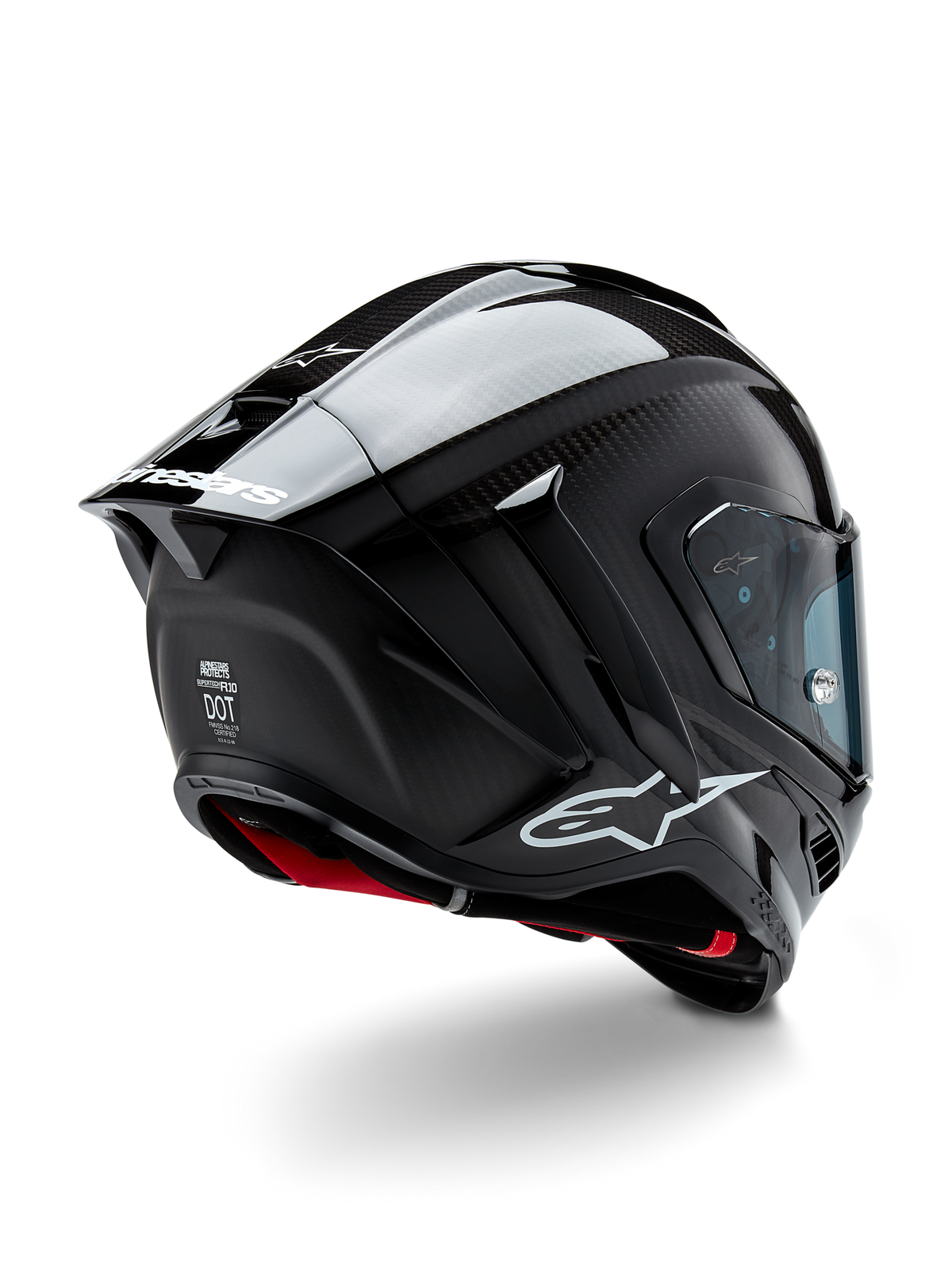 Casco Alpinestars Supertech R10 Solid, casco da racing per moto, finitura in carbonio nero opaco e lucido, vista posteriore a tre quarti che mostra la calotta in fibra di carbonio, lo spoiler aerodinamico e il marchio Alpinestars.