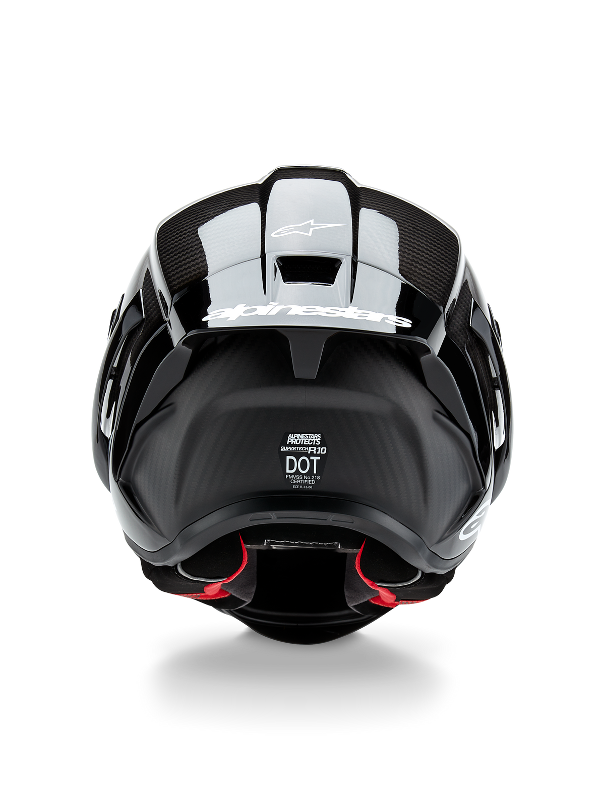 Casco Alpinestars Supertech R10 Solid, casco da moto, carbonio nero opaco e lucido, vista posteriore con trama in fibra di carbonio, spoiler aerodinamico con logo Alpinestars bianco, etichette di certificazione di sicurezza DOT ed ECE e imbottitura interna rossa