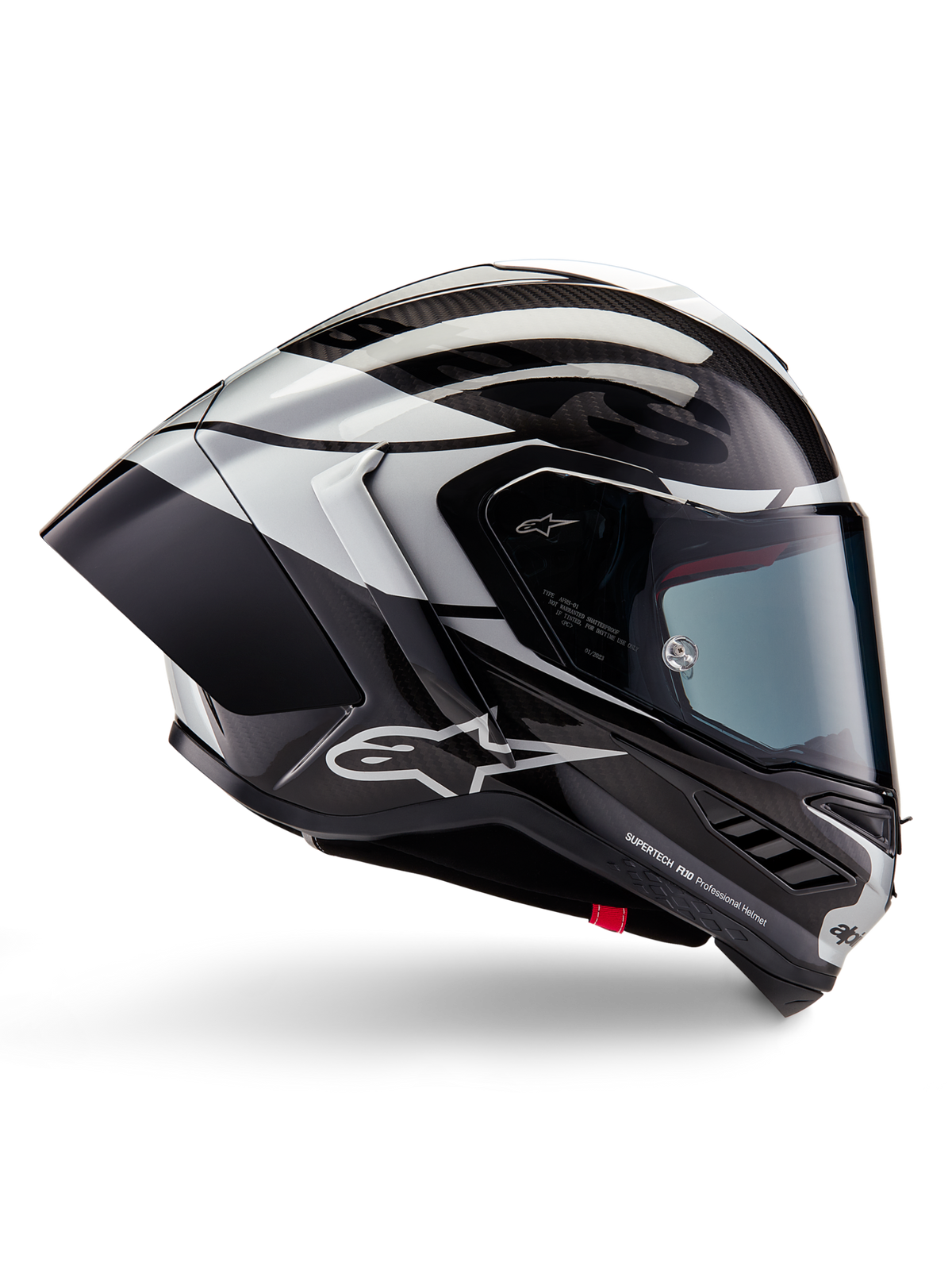 Casco Alpinestars Supertech R10 Element, casco moto integrale racing, finitura in carbonio nero, argento e nero lucido, vista laterale con calotta aerodinamica in fibra di carbonio, visiera trasparente e logo Alpinestars evidente
