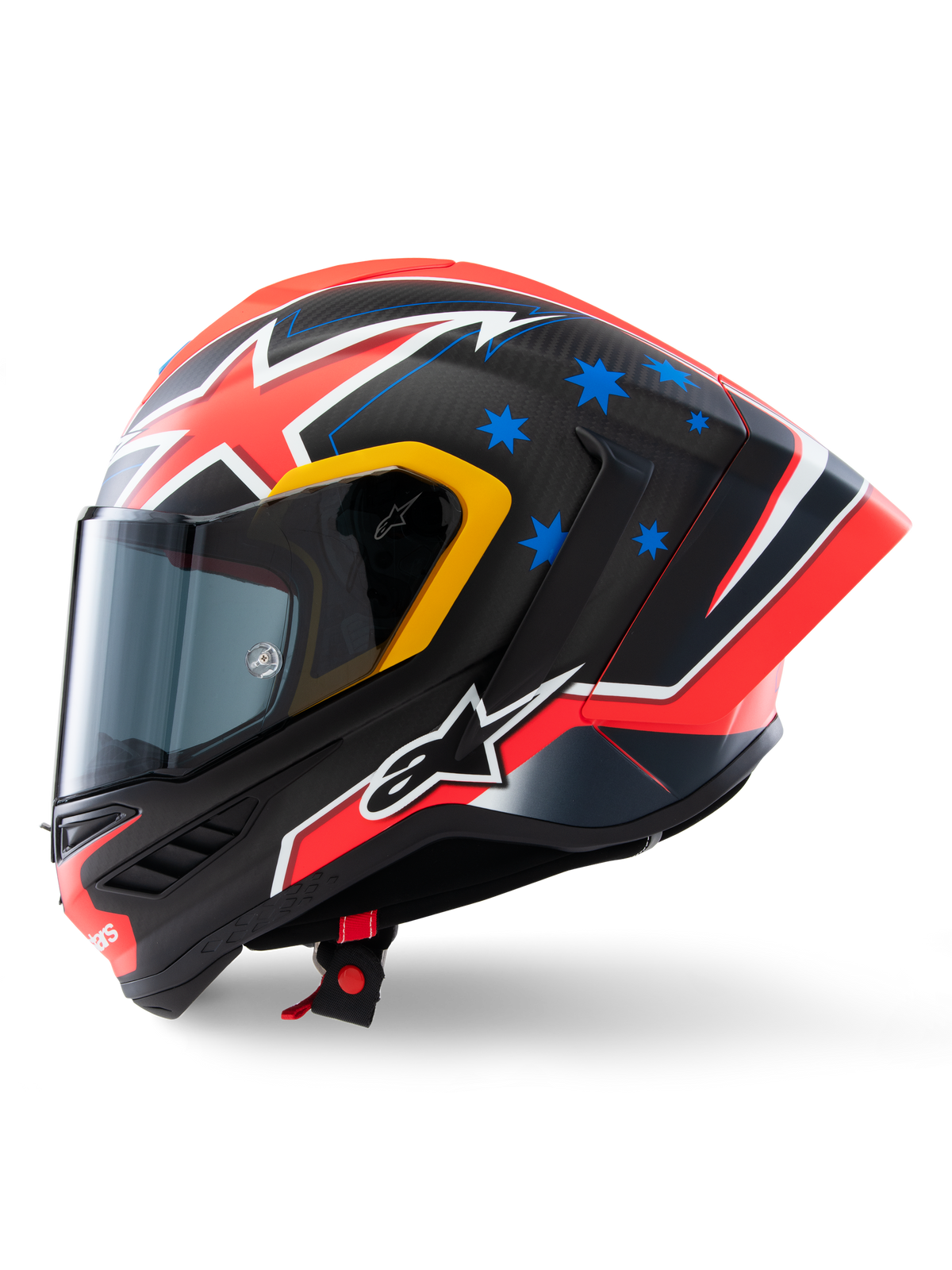 Casco Alpinestars Supertech R10 Miller Limited Edition, profilo laterale, finitura Carbon Red Matt con fibra di carbonio a vista, grafiche a fulmine rosse e bianche, stelle blu sul retro, dettagli gialli sulla visiera e logo Alpinestars bianco, casco da moto da corsa ad alte prestazioni