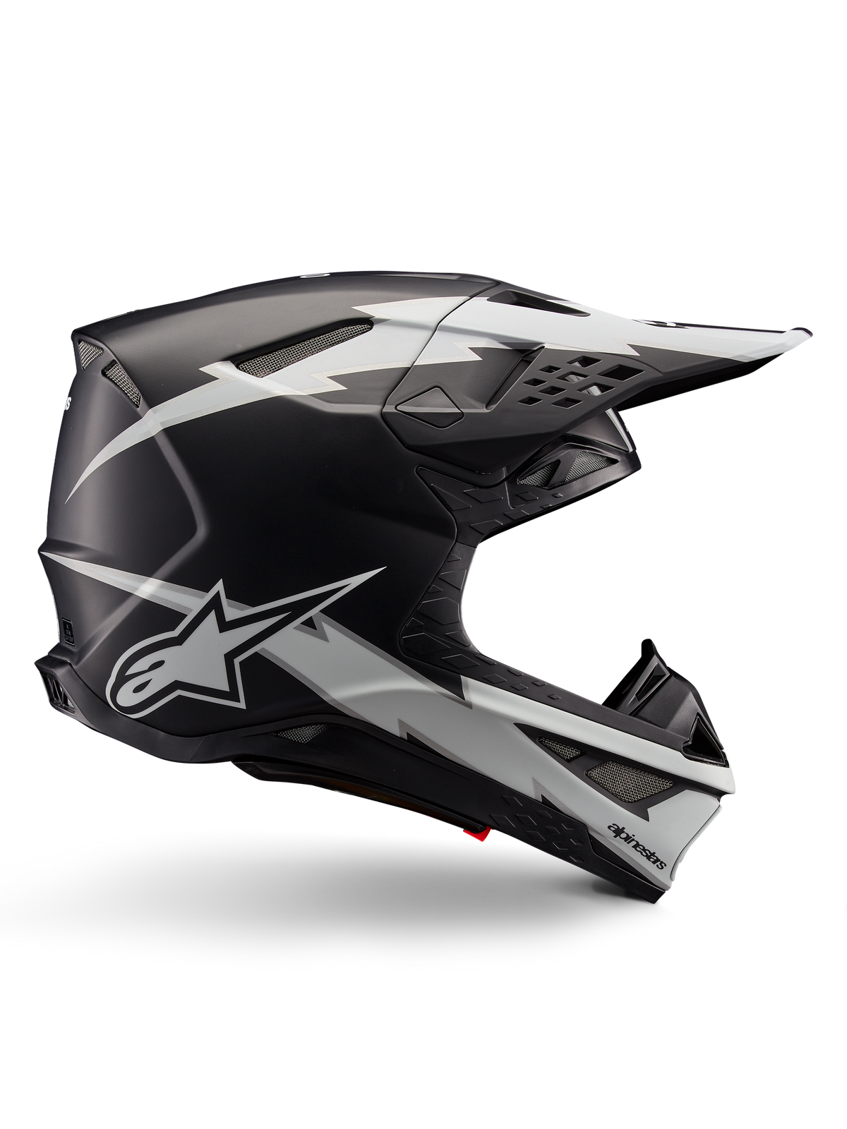 Casco Alpinestars Supertech M10 Ampress, casco da motocross, nero e bianco opaco, profilo aerodinamico con grafiche a fulmine bianco, prese d'aria multiple, visiera parasole estesa, costruzione in fibra di carbonio con finitura opaca