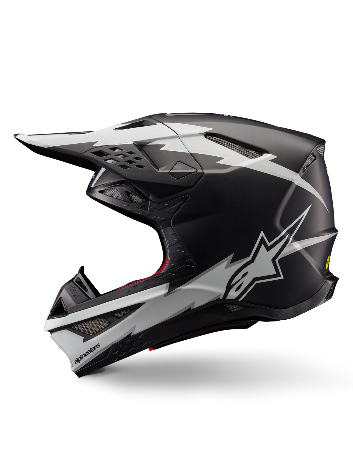 Casco Alpinestars Supertech M10 Ampress, casco da motocross, nero opaco e bianco, vista di profilo con grafiche audaci bianche in stile fulmine, calotta aerodinamica con prese d'aria visibili e visiera, protezione avanzata per il fuoristrada