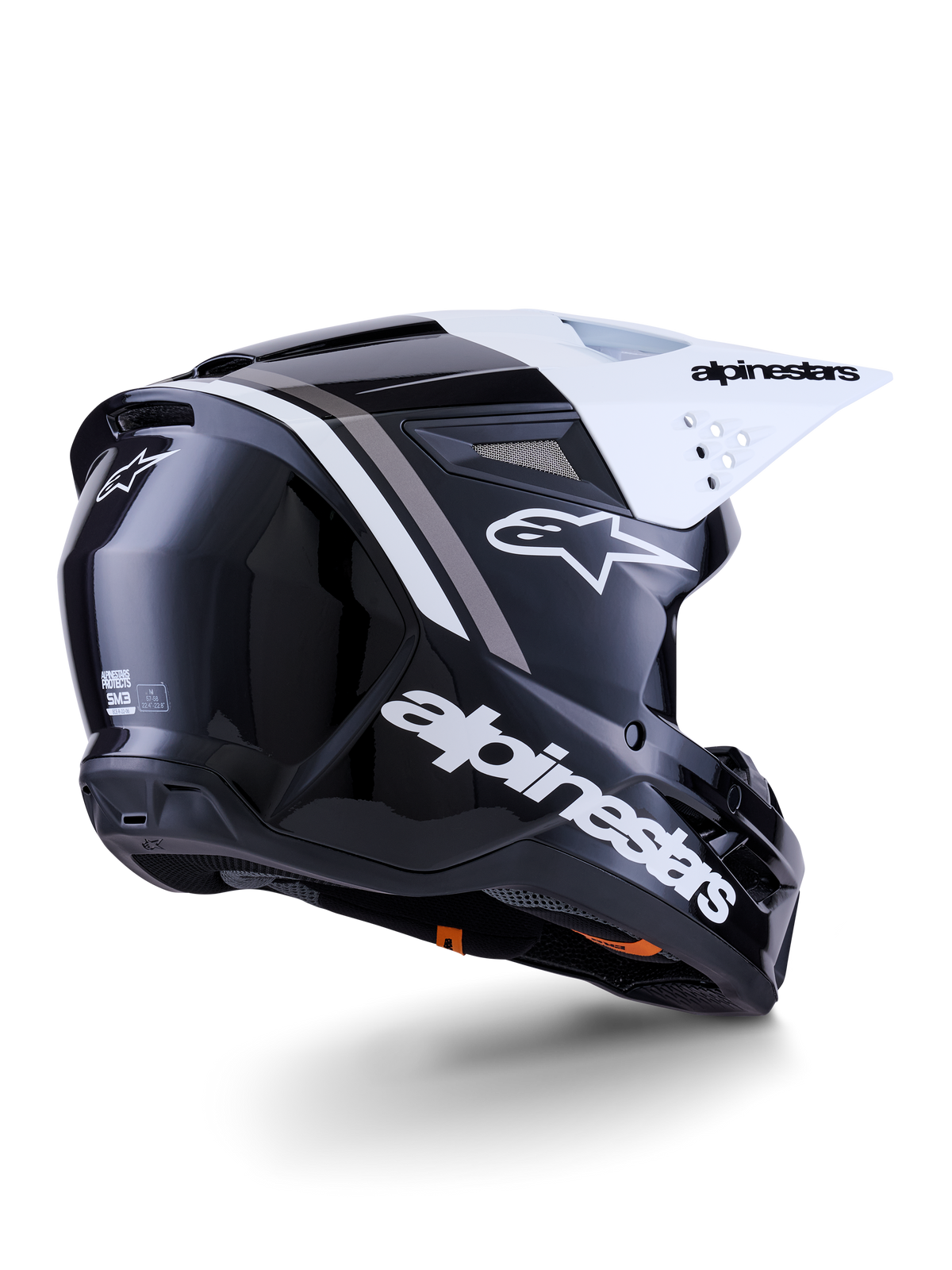 Casco Alpinestars S-M3 Radium, casco da motocross, nero, bianco e grigio lucido, vista posteriore-laterale con visiera bianca, con logo Alpinestars sul lato e sul retro, calotta aerodinamica con rete di ventilazione, progettato per motocross fuoristrada ed enduro