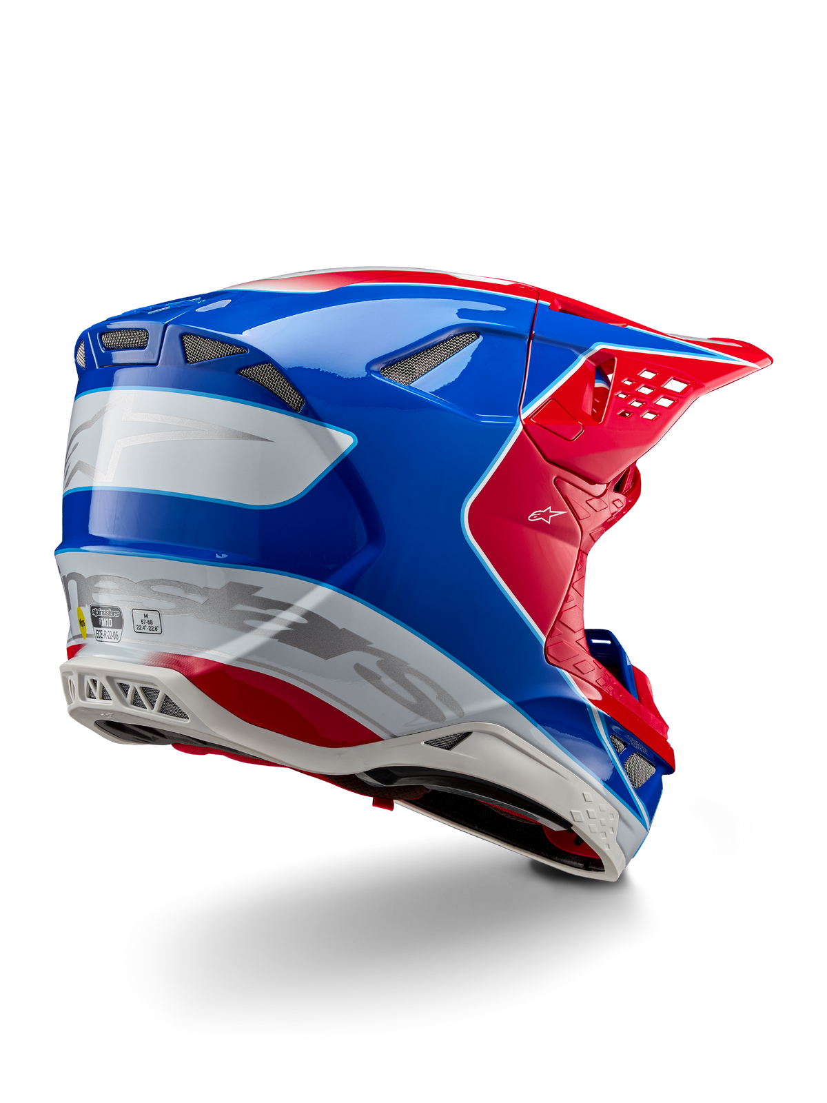 Casco Alpinestars Supertech M10 Aeon ECE 22.06, casco da motocross, rosso acceso, blu e bianco lucido, vista laterale posteriore con profilo aerodinamico, marchio Alpinestars argento e prese d'aria integrate.