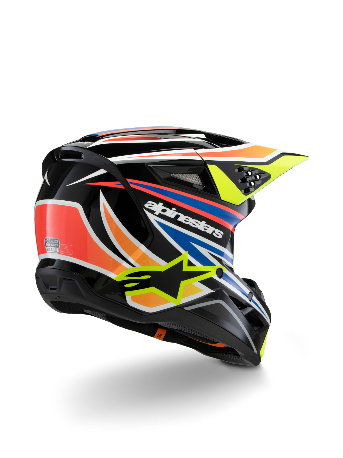 Casco Alpinestars S-M3 Youth Wurx, casco da motocross per ragazzi, nero con vivaci accenti arancione, rosso, blu e giallo fluorescente, vista posteriore a tre quarti che mostra la calotta aerodinamica e le porte di ventilazione, finitura lucida con logo Alpinestars in evidenza