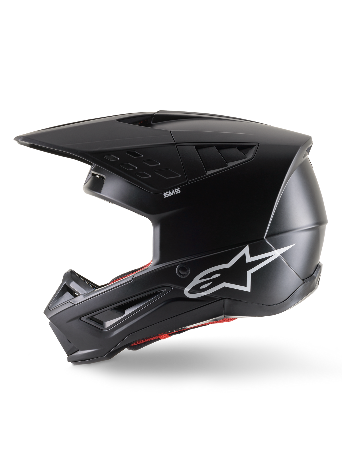 Casco Alpinestars S-M5 Solid ECE 22.06, casco da motocross, nero opaco, vista laterale di profilo con finitura opaca, logo Alpinestars bianco sul lato, imbottitura interna rossa e calotta aerodinamica con porte di ventilazione integrate