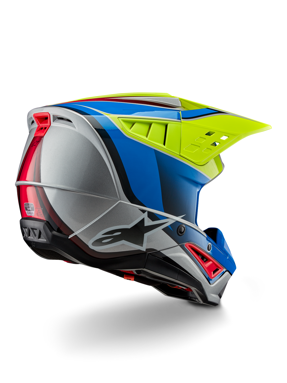 Alpinestars S-M5 Sail Helmet ECE, casco da motocross, giallo fluo, blu smalto e argento lucido, vista posteriore di tre quarti che mostra la calotta aerodinamica in materiale termoplastico, l'ampia visiera ventilata e le prese d'aria integrate per la protezione nelle corse fuoristrada.