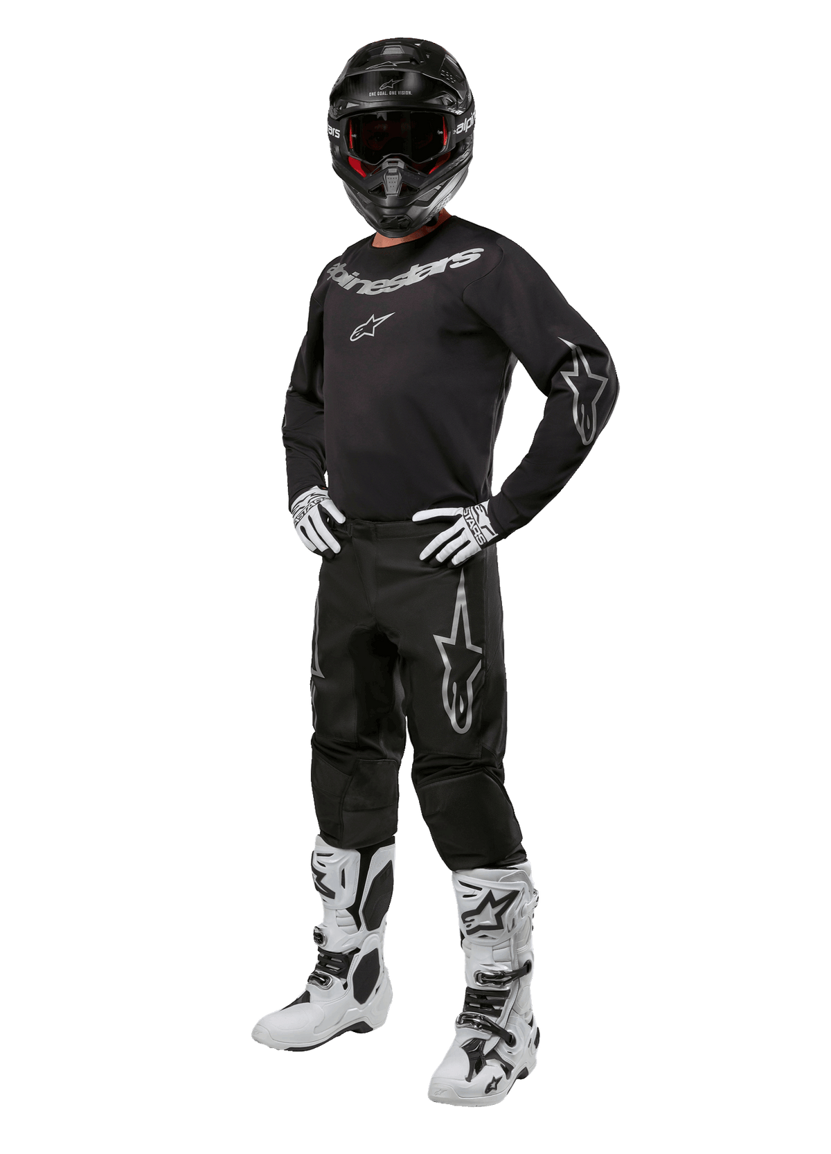 Alpinestars 2024 Fluid Graphite Gear Set, completo motocross nero con loghi grigi e bianchi, maglia e pantaloni abbinati a casco nero coordinato, guanti e stivali bianchi e neri, equipaggiamento protettivo per fuoristrada