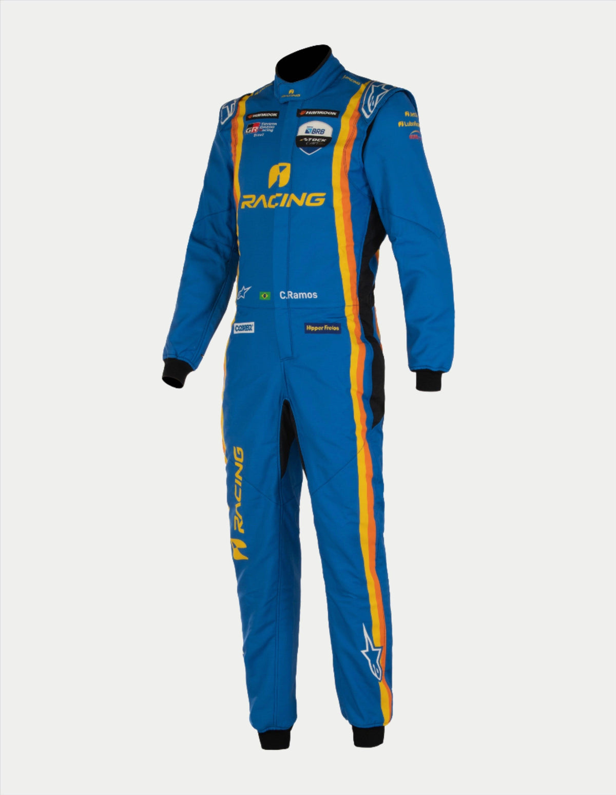 Alpinestars Tech Vision V3 Custom Suit, tuta da gara professionale, blu con strisce gialle e arancioni, con vari loghi degli sponsor e personalizzazione 'C. Ramos', costruzione leggera in Nomex con polsini neri