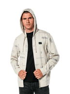 Felpa con cappuccio Alpinestars Plenitude, abbigliamento sportivo casual, felpa Off White con zip frontale e grafiche grigie all-over, indossata da un uomo con il cappuccio alzato sopra una maglia nera, con piccola patch del logo sul petto e tasca a marsupio
