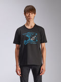 Alpinestars CSF Tee, t-shirt a maniche corte, nera, grafica blu del casco da motocross con logo Astars bianco, streetwear casual ispirato al motorsport indossata da un modello