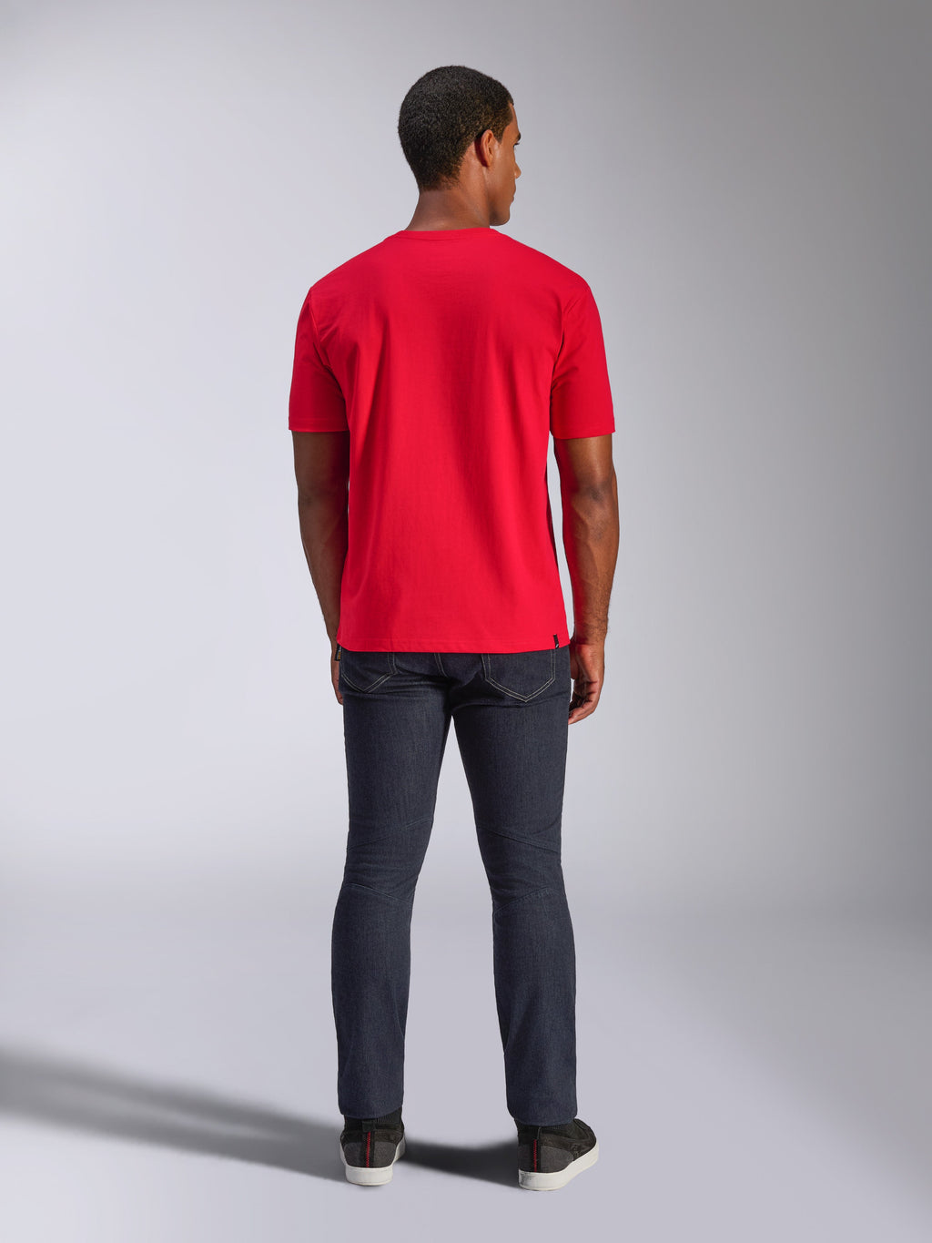 T-shirt Alpinestars CSF, t-shirt a maniche corte, rosso, vista posteriore su modello, abbinata a jeans in denim scuro, streetwear casual ispirato al motorsport