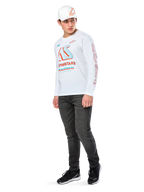 T-shirt Alpinestars Ayess CSF, maglietta a maniche lunghe, bianca, con grandi grafiche racing CSF blu e rosse sul petto e marchio Alpinestars rosso sulla manica, indossata con jeans scuri e un cappellino Alpinestars bianco, streetwear casual motorsport