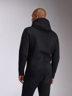 Alpinestars Ellipsoid Hoodie, nero, vista posteriore di una persona che indossa una felpa pullover con cappuccio, maniche lunghe con polsini e orlo a coste, abbinata a jeans neri, abbigliamento sportivo casual ispirato al motorsport